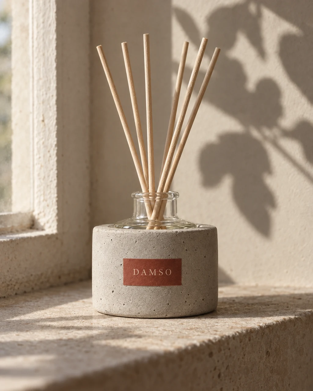 DAMSO reed diffuser on a windowsill