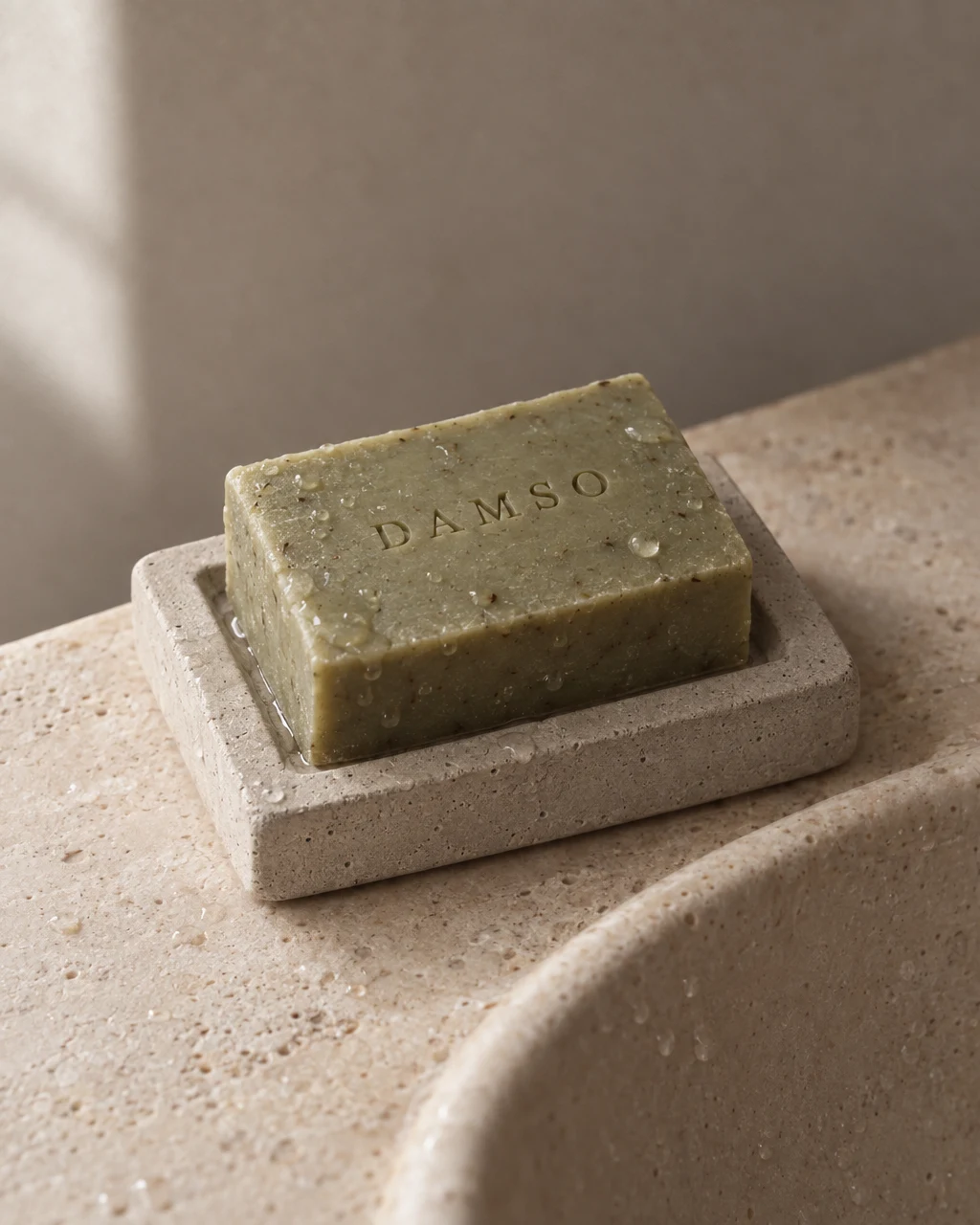 DAMSO olive soap by a stone basin